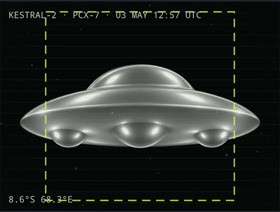 A sighting photograph of a metallic disc with a domed top and three pods underneath, inside a dashed yellow tracking box.